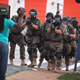 Police force protestors from the business district into nearby neighborhoods on August 11, 2014 in Ferguson, Missouri following the killing of Michael Brown at the hands of police.